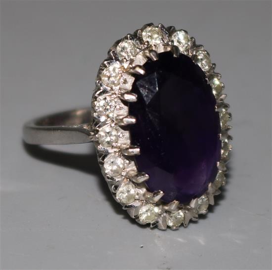 An white 18ct gold, amethyst and diamond oval cluster ring, size P.